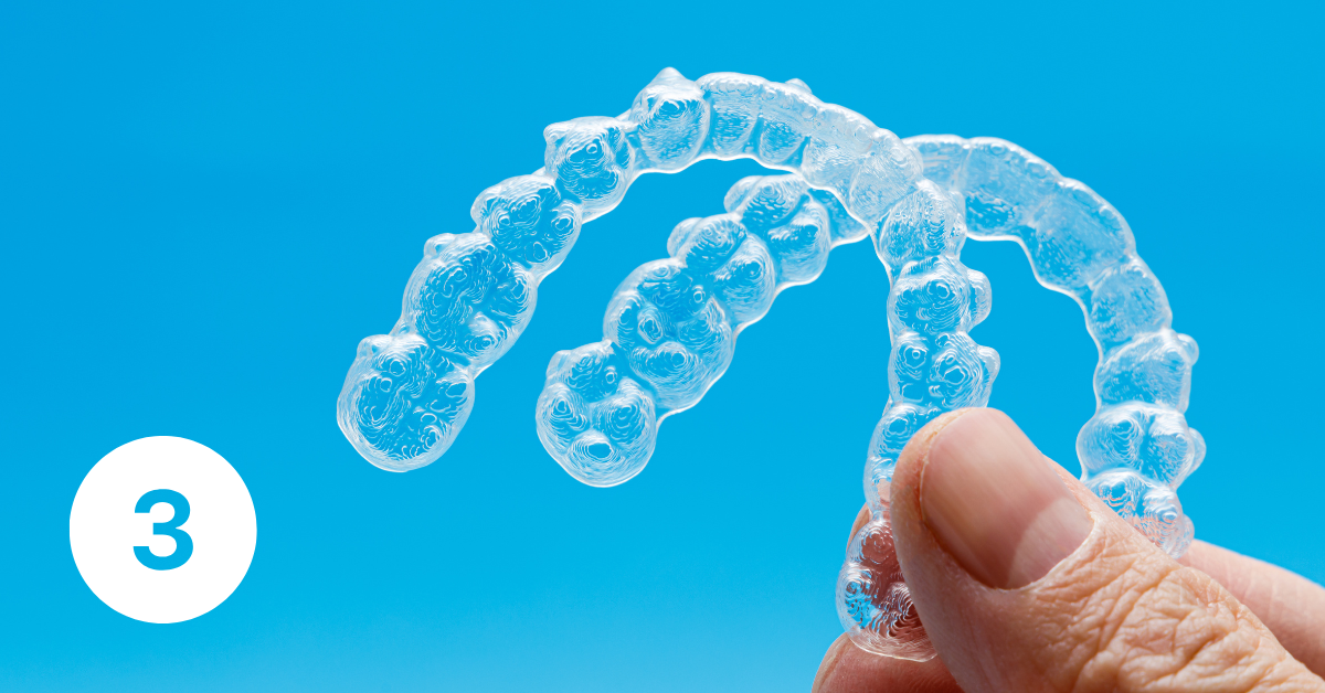 Image of two Invisalign aligners being held up.